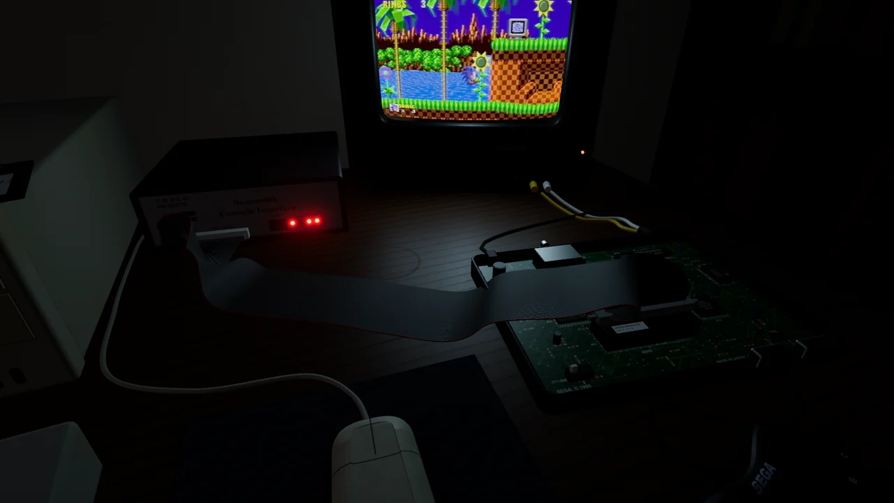 The Console Interface with its red LEDs lit, and a flat ribbon cable running across the desk into the bare Genesis board
